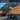 Yellow dump truck with 'CMT96' on a construction site, featuring the Dawnerz brand.